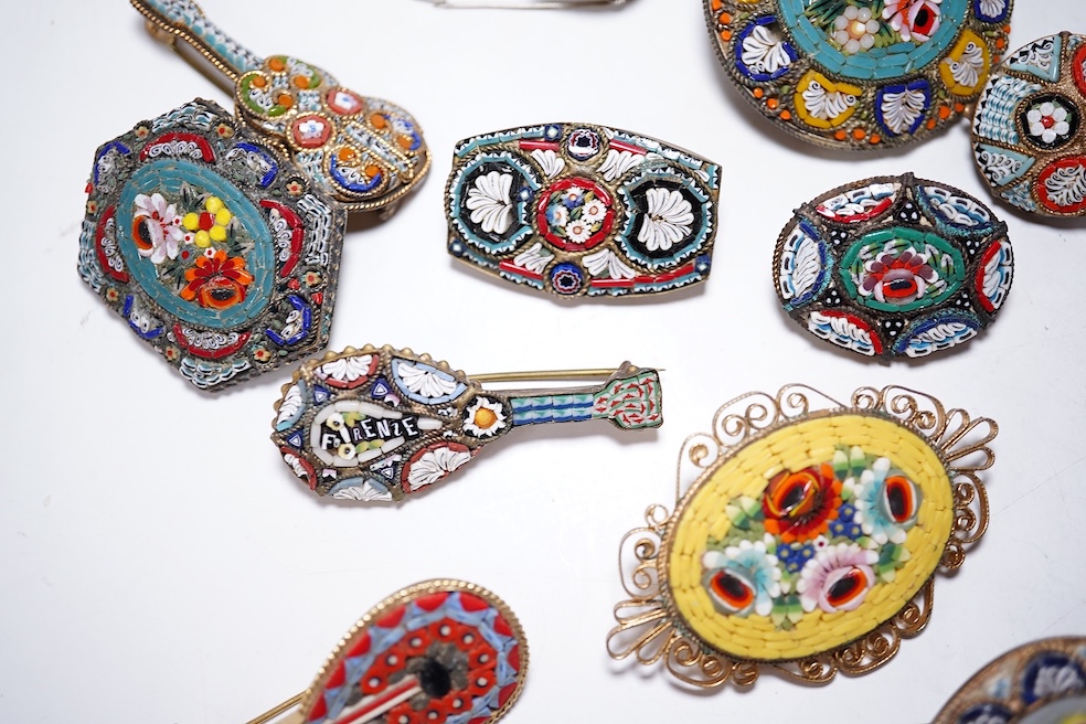A collection of twenty-five micro-mosaic costume jewellery brooches. Including thirteen banjo and guitars shaped brooches, six large oval and circular brooches and six smaller brooches. Condition - mostly good